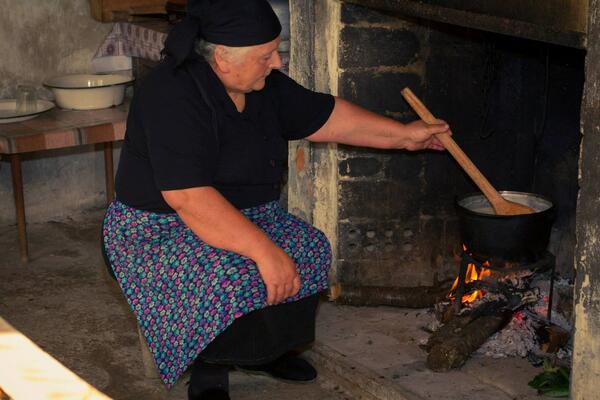 Grandmother cooking by the fire